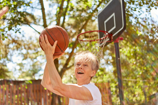 Senior Woman As A Vital Pensioner With Basketball