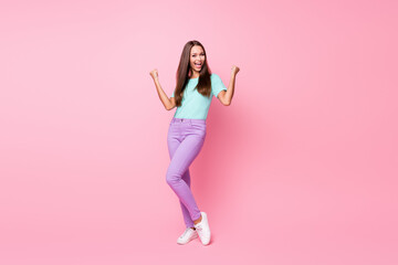 Fototapeta na wymiar Full size photo of young happy attractive smiling cheerful woman dancing wear violet trousers isolated on pink color background