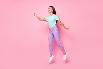 Fototapeta na wymiar Full size photo of young beautiful attractive happy woman smile jump hold invisible umbrella isolated on pink color background