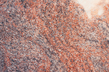 textured surface of multicolored granite stone, top view