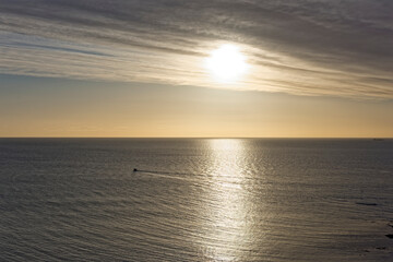 A small Private Fishing Boat out in the Bay of Auchmithie tending to its Crab Pots on a calm early morning, with its wake stretching behind it.