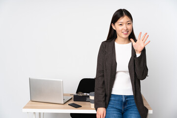 Business asian woman in her workplace isolated on white background counting five with fingers