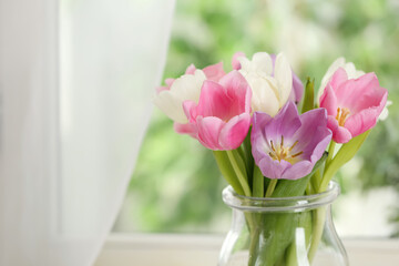 Fototapeta na wymiar Beautiful fresh tulips near window indoors. Spring flowers