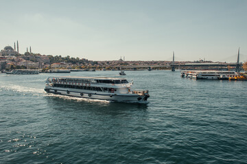 view of city from Bosphorus strait with floating and moored ships, Istanbul, Turkey