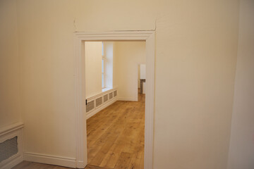 Large cracks in a white wall. Dilapidated wall 