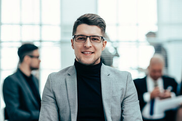 confident business man standing in the office