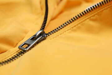 Yellow jacket with zipper as background, closeup view