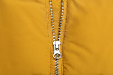 Yellow jacket with zipper as background, top view