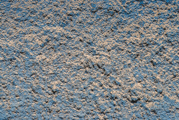 Blue plastered house facade wall detail closeup as grunge background