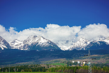 high tatra mountain ridge in springtime. cloud above the snow capped rocky peaks. beautiful sunny weather. wonderful nature scenery