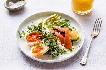 Healthy breakfast with egg, smoked salmon and avocado