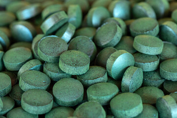 Fototapeta na wymiar Stack of Spirulina green pills