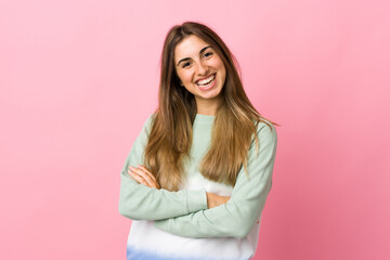 Fototapeta premium Young woman over isolated pink background keeping the arms crossed in frontal position