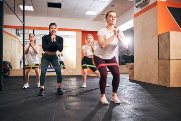 Slim and strong women exercising with resistance bands
