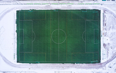 Aerial view of the outdoor football heated field in winter, Finland.