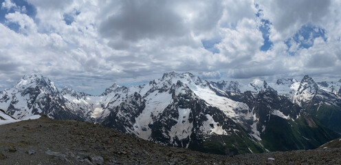 Wide panorama of the mountain peaks of the Caucasian ridge