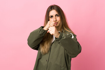 Young woman over isolated pink background with fighting gesture