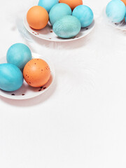 Colored eggs on plate with on white background. Copy space.  Easter concept.