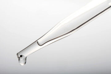 Pipette with clear liquid and droplet