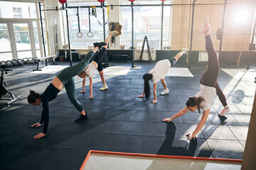 Strong young women doing some yoga on a sunny day