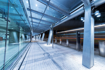 Modern pedestrian walkway in midtown of Hong Kong city at night