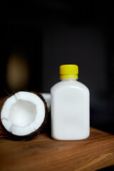 Fresh healthy coconut milk in a glass on wooden table background