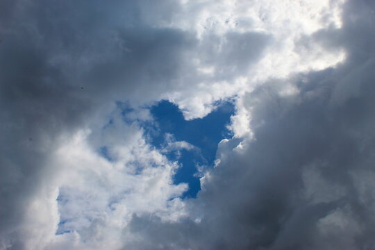 A cloudy sky that clouds covered all but the shape of the heart of the sky.