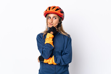 Young hispanic cyclist woman isolated on white background having doubts