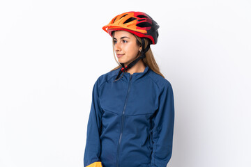 Young hispanic cyclist woman isolated on white background looking to the side