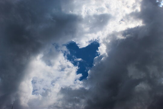 A cloudy sky that clouds covered all but the shape of the heart of the sky.