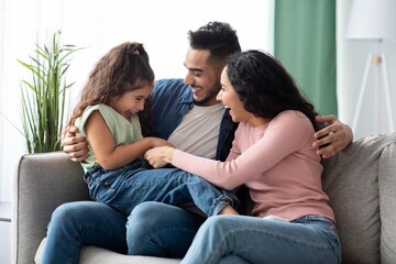 Cheerful Arabic Family Of Three Having Fun At Home, Laughing Together