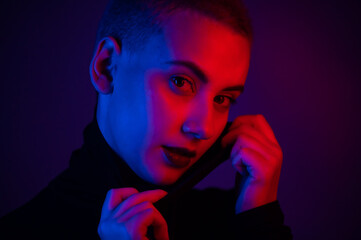 Portrait of a beautiful young woman with short hair in neon light