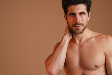 Fototapeta premium Shirtless masculine man posing and looking at camera