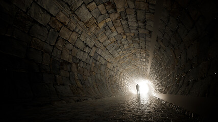 Obraz premium Concept or conceptual dark tunnel with a bright light at the end or exit as metaphor to success, faith, future or hope, a black silhouette of walking man to new opportunity or freedom 3d illustration