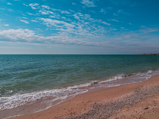 Empty beach with blue sea and sky background on a sunny day. South scenic landscape wallpaper, autumn winter sping summer vacation season. Vivid blue water with blurred copy space. Resorts advertising