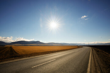 landscape with agricultural field and mountains in the background
