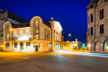 Architecture of Alesund city reflected in the water at night, Norway