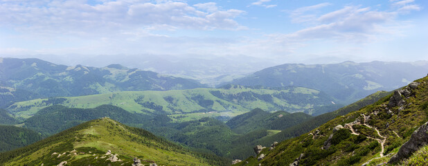 Mountain valley and mountain ranges against the sky with clouds