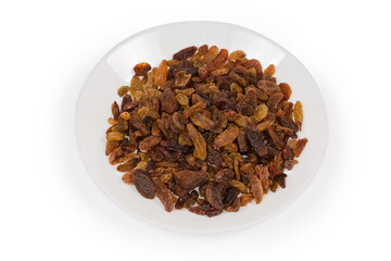 Dark yellow raisins on dish on a white background