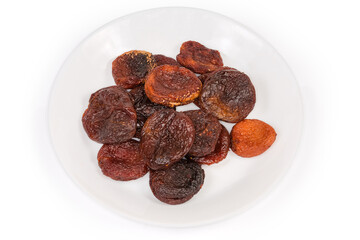 Dried smoked apricots on a white dish