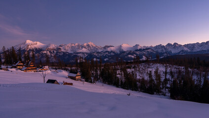 Scenic image of mountain landscape during sunset. Colorful sky over the snowcowered mountain and frozen landscape under vivid pink sunlight. Stunning nature background. Tatras zakopane poland
