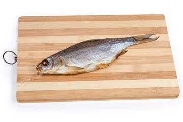 Salted and dried roach on a wooden cutting board
