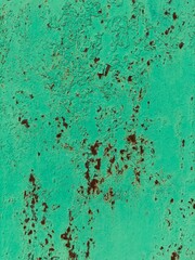 rusty metal covered with green paint