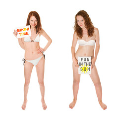 Full length portraits of two beautiful young women wearing white bikinis and holding papers in their hands, bikini time and fun in the sun is written on the papers, isolated on white studio background