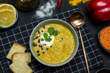lentil soup. croutons, coconut cream and herbs, spices and ingredients. vegetarian food 