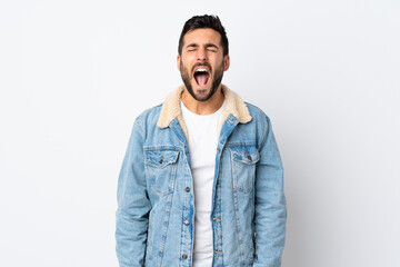 Young handsome man with beard isolated on white background shouting to the front with mouth wide open