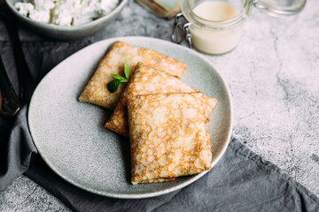 crepes with homemade cottage cheese on a gray plate