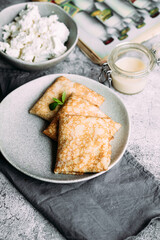 crepes with homemade cottage cheese on a gray plate