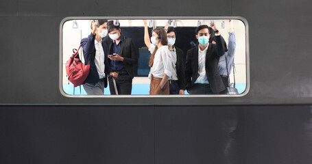 people with mask travel Public electric train, Businessman or woman wearing white facial mask during travel by Public electric train, new normal life style during covid-19 pandemic 