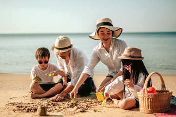 Happy parents and kid having fun with playing sand in summer vacation on the beach.Travel,Happy...
